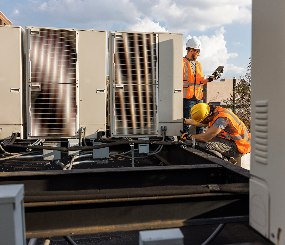 Crew servicing commercial HVAC equipment