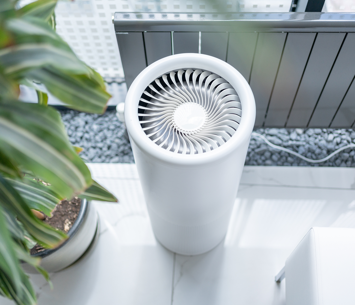 Modern air purifier on tiled floor