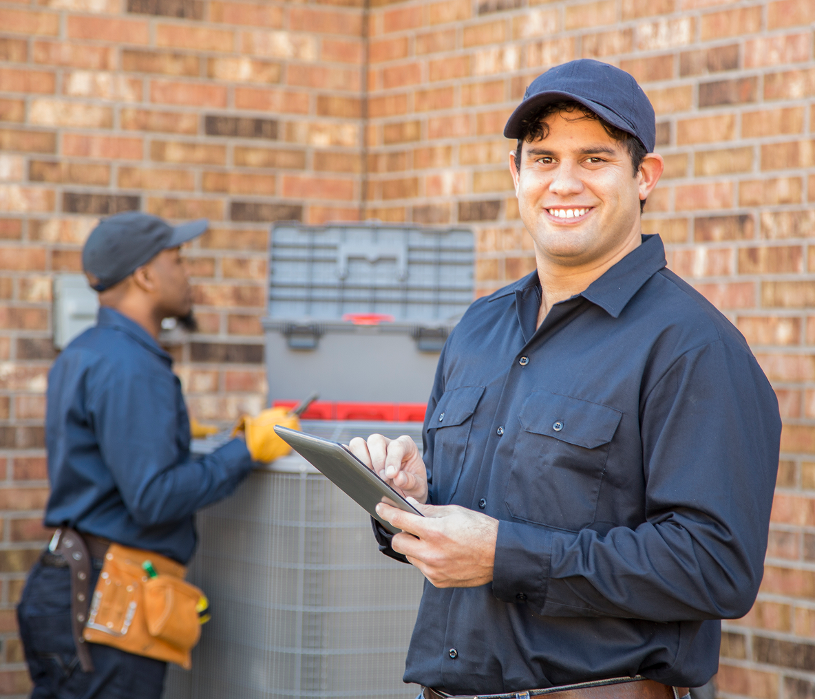 Smiling technician holding a tablet